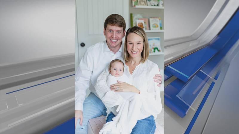 Matthew and Kendall Henderson pose for a photo with baby Lily Ruth.