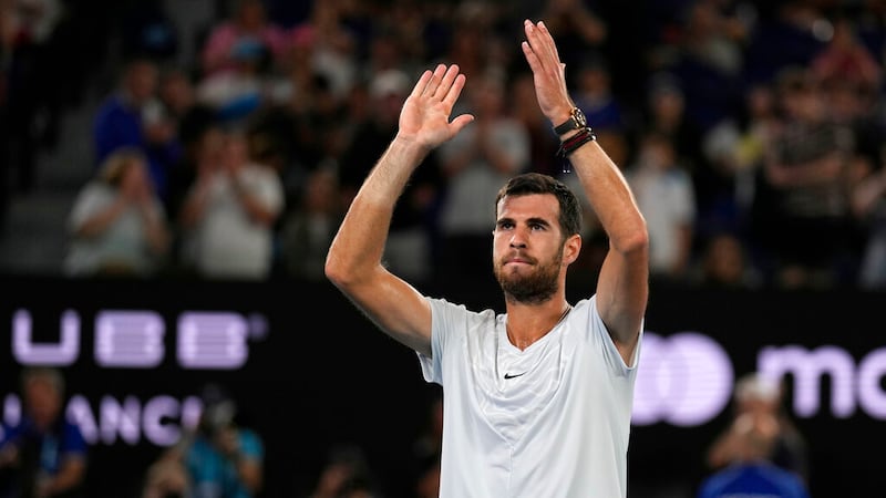 Karen Khachanov of Russia waves after Sebastian Korda of the U.S. withdrew their quarterfinal...