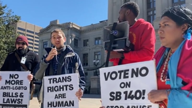 Protesters stand in opposition for senate bill 140 outside of the Georgia Capitol.