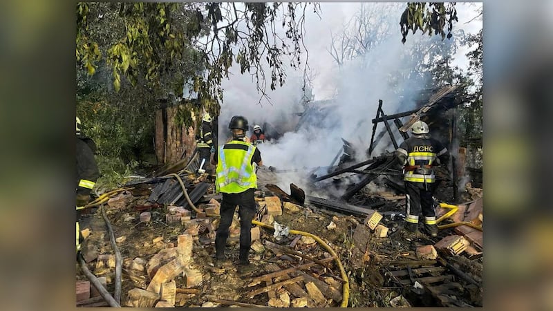 Debris and smoke is seen in the aftermath of an attack on Kyiv on Wednesday.