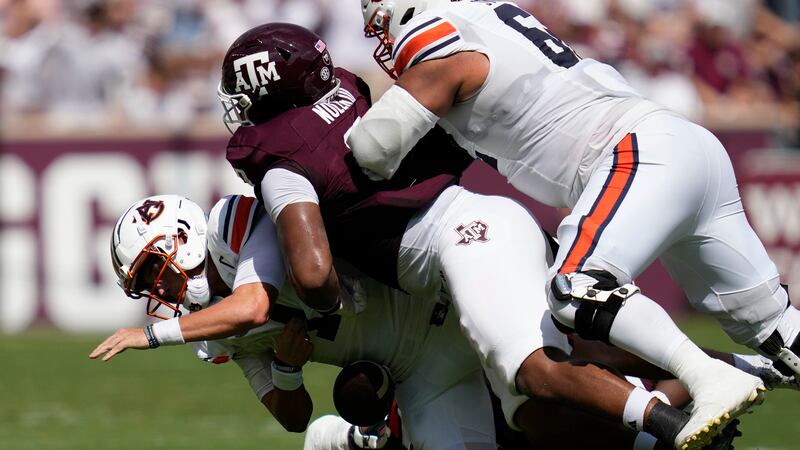 Auburn quarterback Payton Thorne, left, is sacked by Texas A&M defensive lineman Walter Nolen,...