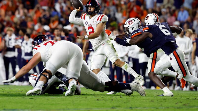Mississippi quarterback Jaxson Dart (2) throws a pass as he is pressured by Auburn linebacker...
